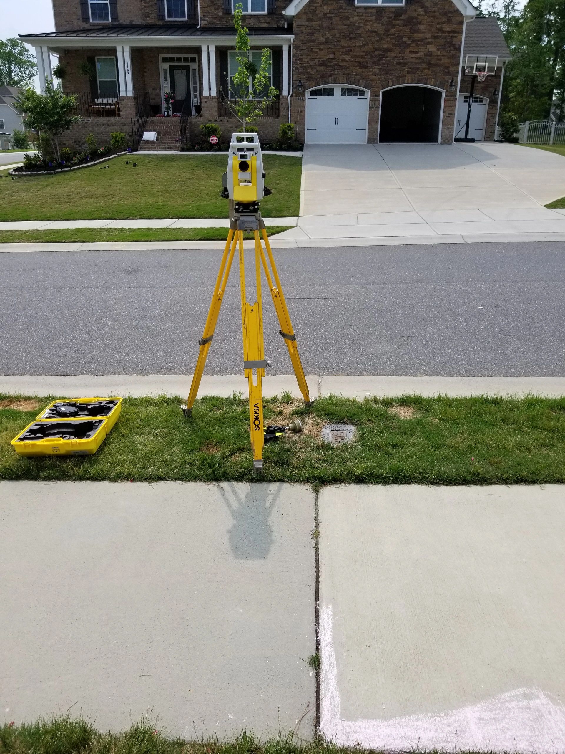 Surveying theodolite on residential street